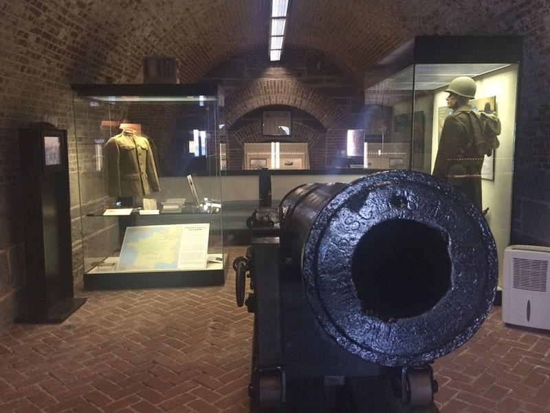 Several exhibits inside the Harbor Defense Museum including a canon.